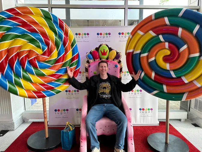 Brian sitting in a candy throne